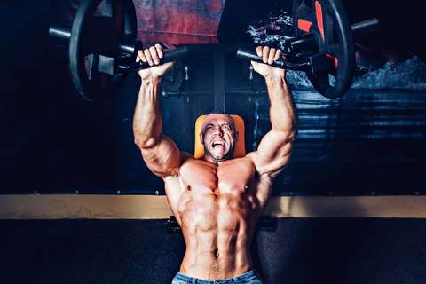 Man working out with chest machine presses